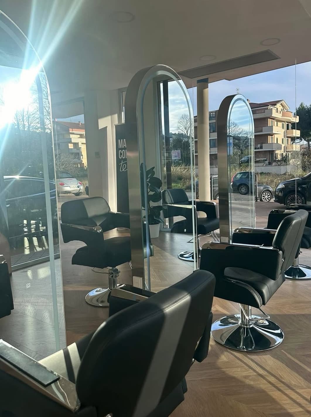 Il salone luminoso di Amira Beauty Suite con specchi e poltrone nere